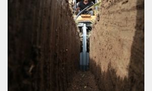 Chain Trencher (Model TN548) digging a trench.